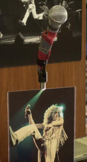 Derik Holtmann/News-Democrat Microphone, duct tape and all, used by Roger Daltrey for the Who’s Next tours, with photo of Daltrey using mic during a concert.