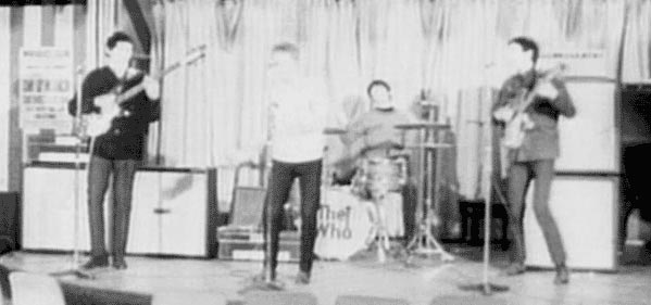 Ca. 1965, at the Marquee, John playing Rickenbacker Rose, Morris, Co. LTD., 1999 (4001S) bass, and two Marshall 4×12 cabinets side-by-side, powered by Marshall JTM45 50-watt amp.