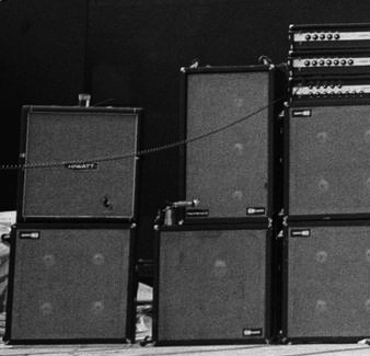 Ca. 1972, detail of the Sunn rig, with one Sunn Coliseum Bass (top), one Sunn Coliseum 880 (middle), and one Sunn Coliseum Lead (bottom). Cabinets are two Sunn 3×12 (outside top, fitted with <em>Ye Old Music Shop</em> of Marissa, Illinois, badges), two Sunn 4×12 (inside), and two Sunn 1×18 (outside bottom).