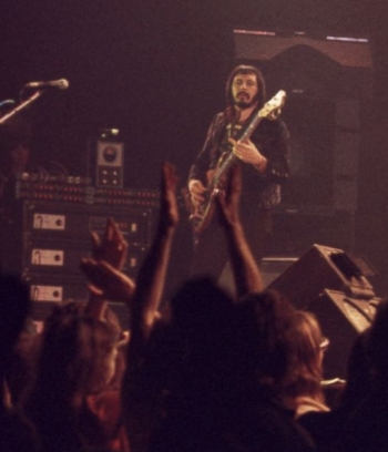 26 November 1975, with Alembic Series 1 bass in zebra wood. Alembic/Sunn Coliseum Power Amp amplifier rack visible at left.