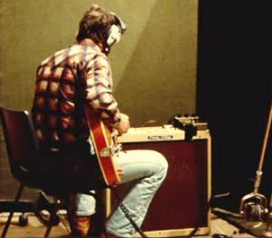 Click to view larger version. Ca. 1976/77, at Olympic Studios, recording Rough Mix, with Gretsch Chet Atkins, coil cable and Big Muff Pi fuzz pedal, and Peavey Vintage 4×10.