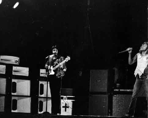 14 June, 1974, at Madison Square Garden, John in front of Heil PA sidefill monitor stacks with white-painted horn bells. Photo courtesy Dave Kleinwaks.