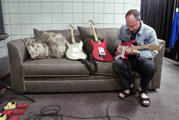 Ca. 2000, Pete in the dressing room with a collection of LED and non-LED MXR Dyna-Comp pedals and Boss OD-1 overdrive pedals. Guitars are Fender Eric Clapton model Stratocasters.