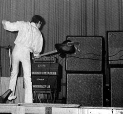 In ’67, with one ’65 Marshall JTM45 100 Super P.A. 100-watt head used as a guitar amp (top with block logo), one Marshall 1959 JTM100 Super Lead heads (bottom, with script logo), topped with Grampian reverb unit. Speakers are, on left, two Sound City 4×12 cabinets, and on right, Marshall 1982A, top, and Marshall 1982B, bottom. Guitar is Fender Telecaster.