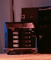 Ca. 1985, custom amp rack, with four Stramp 4120 stereo preamps, Alembic input module/splitter, and four Sunn Coliseum Slave power amps.