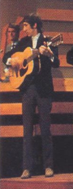Ca. 1966, with the Harmony 12 during television performance. Note red capo at 2nd fret.