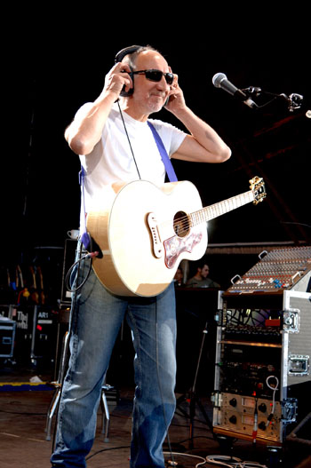 Ca. 2006, wearing headphones (to protect from feedback through monitors) with Gibson Signature SJ-200 equipped with Fishman Ellipse Matrix Blend pickup system.