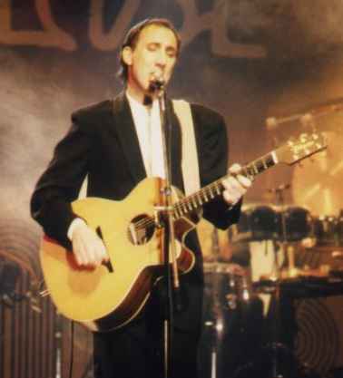 29 January 1986 at Midem, Cannes, with Deep End, playing a Takamine EG40SC.